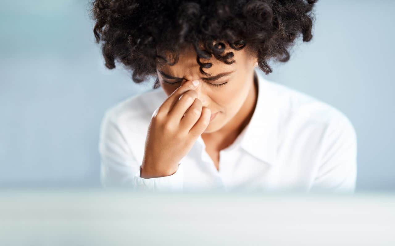 A woman suffering from nasal congestion.